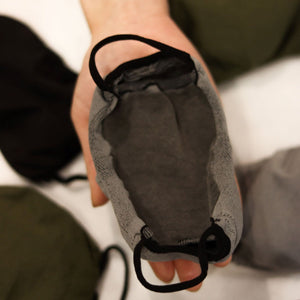 
                  
                    Triple-layer mask held in hand
                  
                