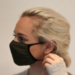 Woman wearing olive triple-layer reusable standard mask