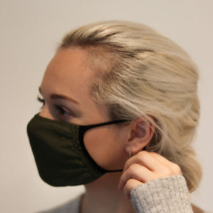 
                  
                    Woman wearing olive triple-layer reusable standard mask
                  
                